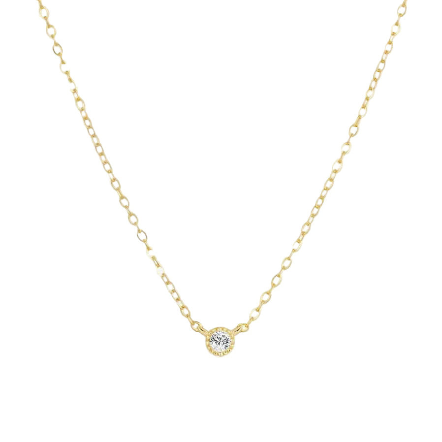 Gold necklace with a small diamond pendant on a white background